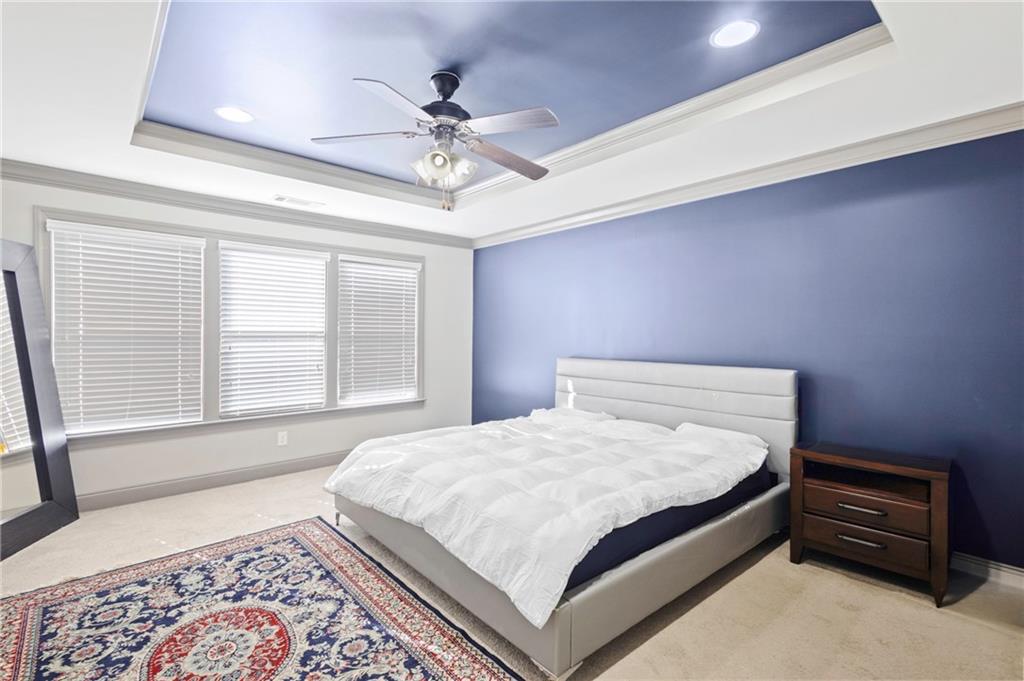 1802 Stephanie Trail Northeast Atlanta, GA 30329 - Photo 14 of 25 a bedroom with a bed and a chandelier