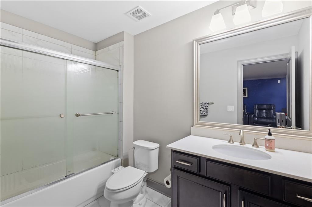 1802 Stephanie Trail Northeast Atlanta, GA 30329 - Photo 20 of 25 a bathroom with a sink a toilet a mirror and shower