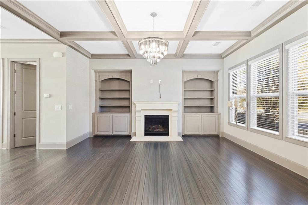 1802 Stephanie Trail Northeast Atlanta, GA 30329 - Photo 2 of 25 wooden floor in an empty room with a fireplace