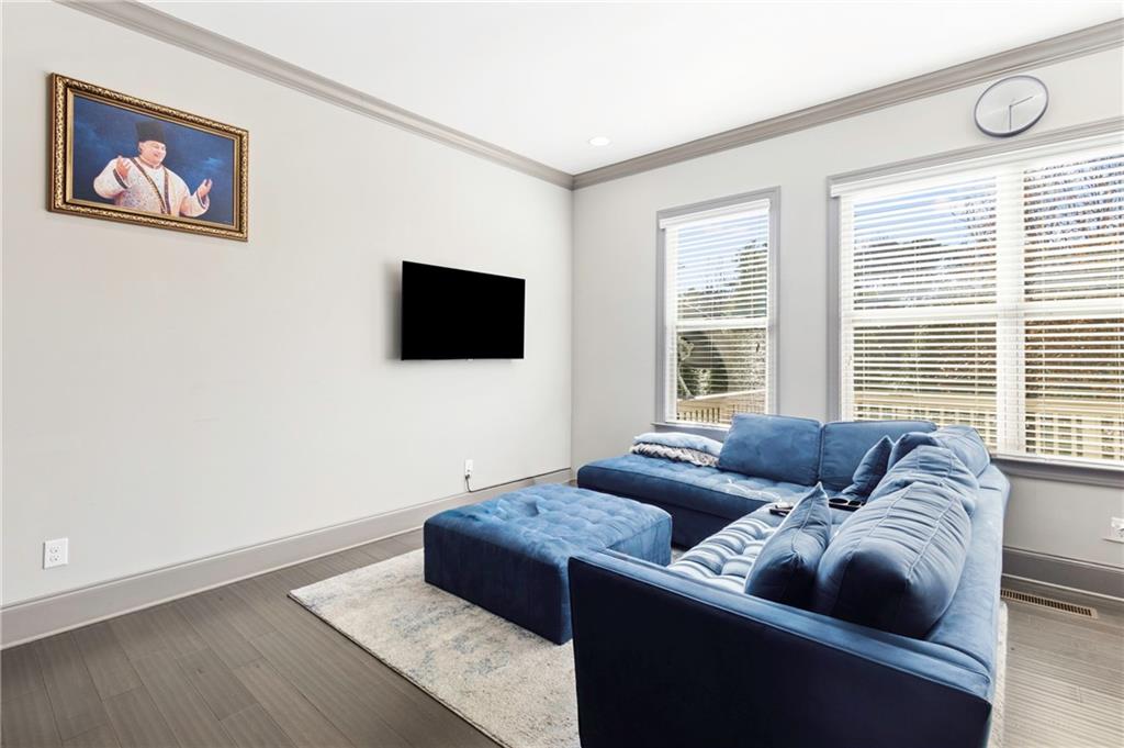 1802 Stephanie Trail Northeast Atlanta, GA 30329 - Photo 8 of 25 a living room with furniture and a flat screen tv