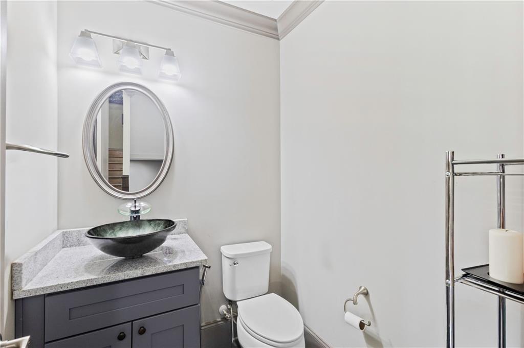 1802 Stephanie Trail Northeast Atlanta, GA 30329 - Photo 10 of 25 a bathroom with a toilet a sink and a mirror