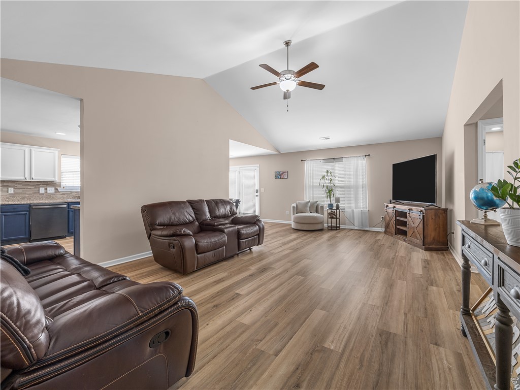 2520 Linmar Circle Anderson, SC 29621 - Photo 9 of 50 A spacious living room features vaulted ceilings, hardwood flooring, and an open-concept flow to the kitchen.