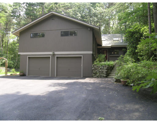 49 Campbell Road Wayland, MA 01778 - Photo 12 of 15 a front view of a house with a yard and garage