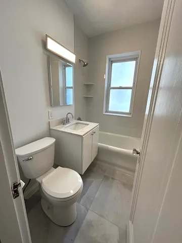 a white toilet sitting next to a bathroom sink
