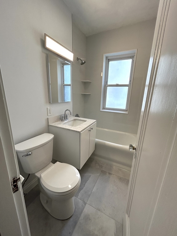 1666 Commonwealth Avenue, Unit 24 Boston, MA 02135 - Photo 11 of 16 a white toilet sitting next to a bathroom sink