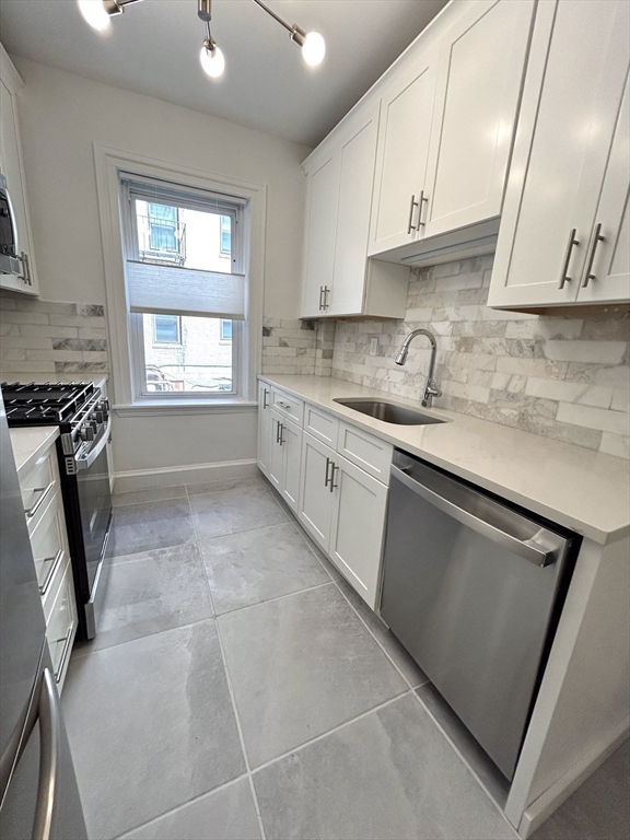 1666 Commonwealth Avenue, Unit 24 Boston, MA 02135 - Photo 4 of 16 a kitchen with a sink a stove and cabinets