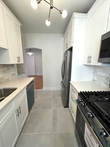 a kitchen with a sink appliances and cabinets