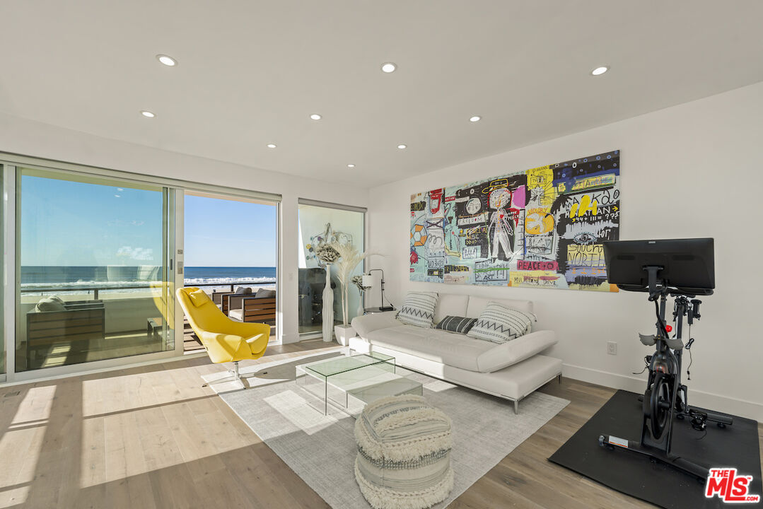 1 Eastwind Street, Unit 201 Marina del Rey, CA 90292 - Photo 11 of 40 a living room with furniture and a flat screen tv