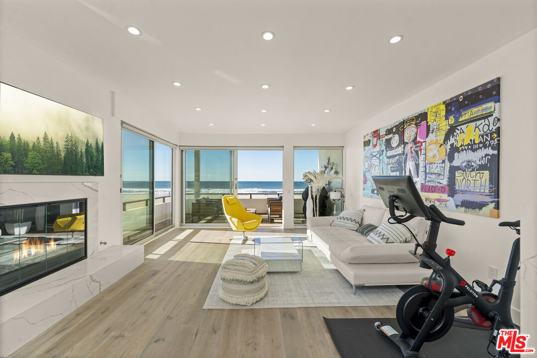 1 Eastwind Street, Unit 201 Marina del Rey, CA 90292 - Photo 12 of 40 a living room with furniture and a fireplace