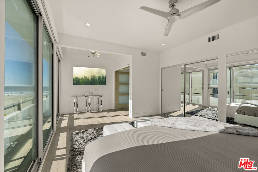 1 Eastwind Street, Unit 201 Marina del Rey, CA 90292 - Photo 16 of 40 a bedroom with a bed and a large mirror