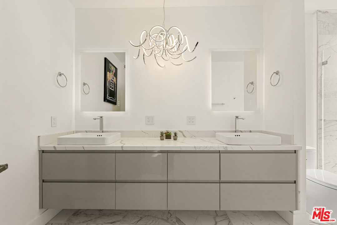 1 Eastwind Street, Unit 201 Marina del Rey, CA 90292 - Photo 17 of 40 a bathroom with a double vanity sink and mirror