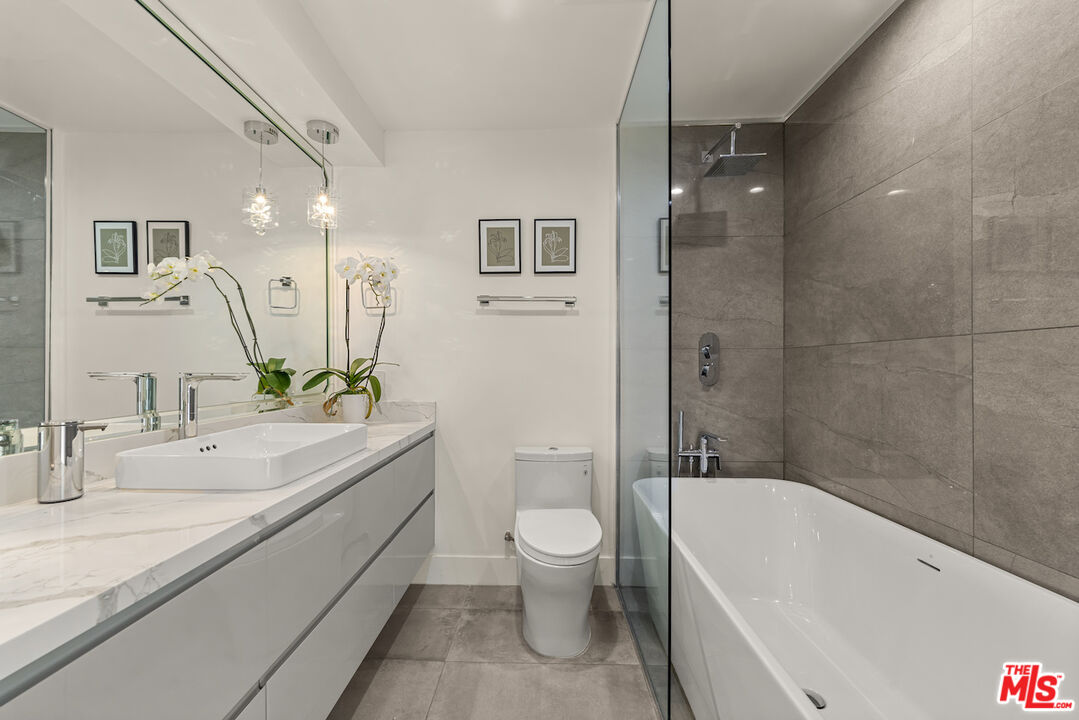 1 Eastwind Street, Unit 201 Marina del Rey, CA 90292 - Photo 18 of 40 a bathroom with a granite countertop sink a toilet and bathtub