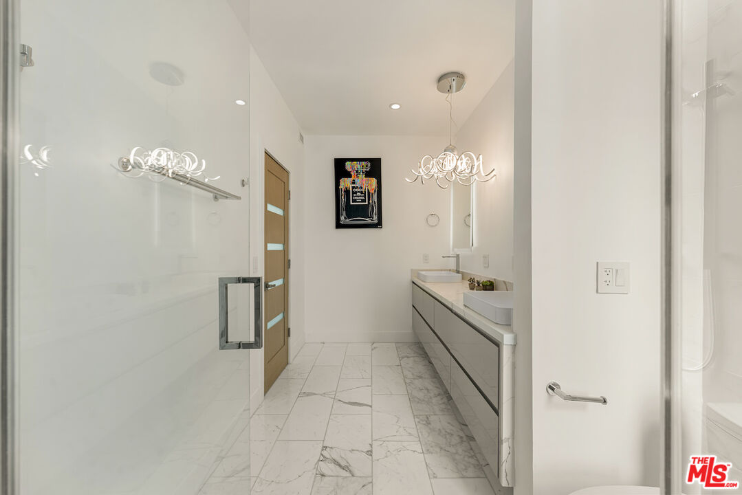 1 Eastwind Street, Unit 201 Marina del Rey, CA 90292 - Photo 20 of 40 a bathroom with a double vanity sink and a mirror