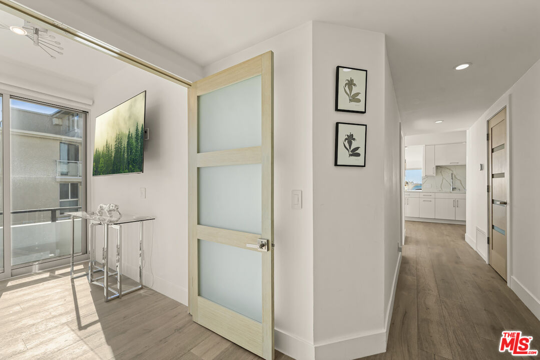 1 Eastwind Street, Unit 201 Marina del Rey, CA 90292 - Photo 21 of 40 a view of a hallway with wooden floor and a living room