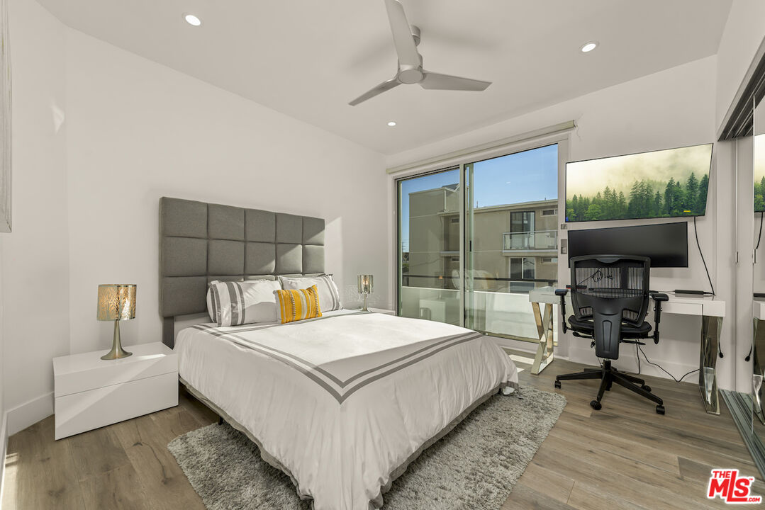 1 Eastwind Street, Unit 201 Marina del Rey, CA 90292 - Photo 22 of 40 a bedroom with a bed and a table