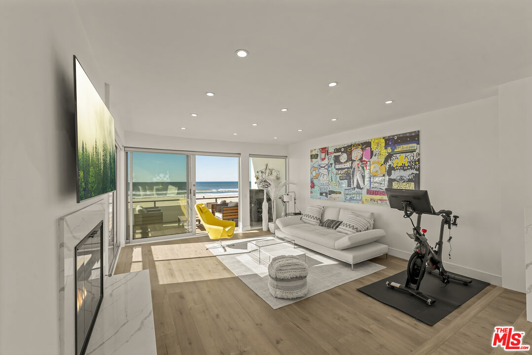 1 Eastwind Street, Unit 201 Marina del Rey, CA 90292 - Photo 7 of 40 a living room with furniture a flat screen tv and a floor to ceiling window