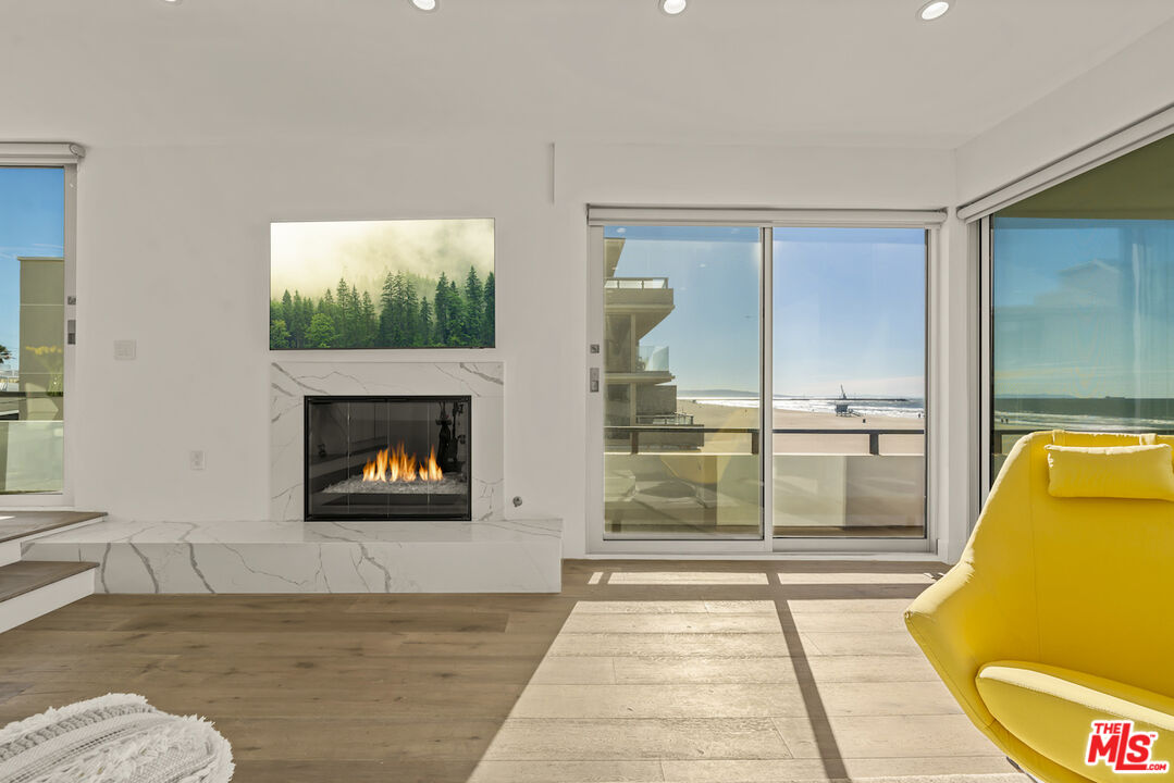1 Eastwind Street, Unit 201 Marina del Rey, CA 90292 - Photo 9 of 40 a living room with furniture and a fireplace