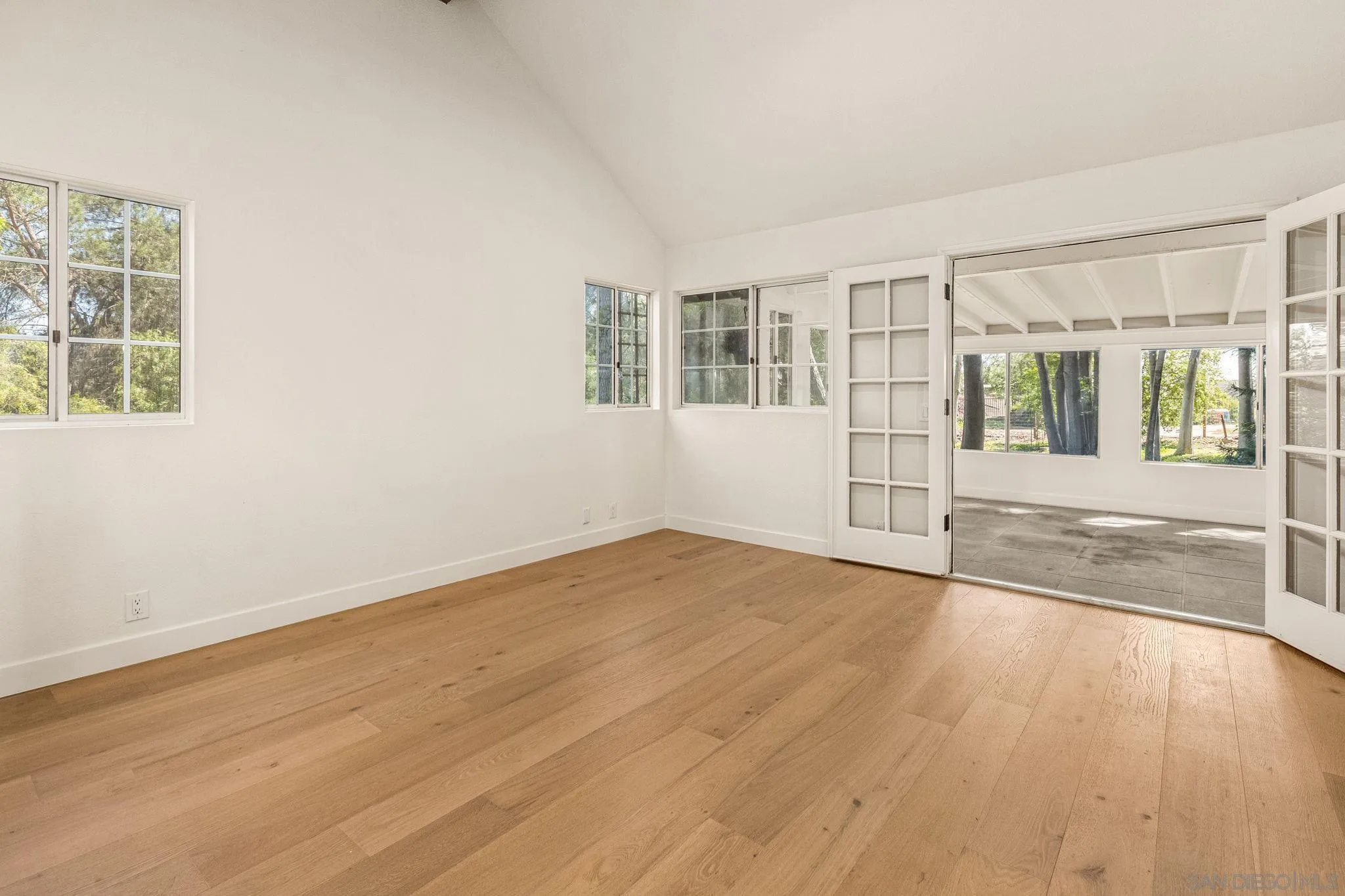 2029 Winterwarm Drive Fallbrook, CA 92028 - Photo 27 of 36 an empty room with wooden floor and windows