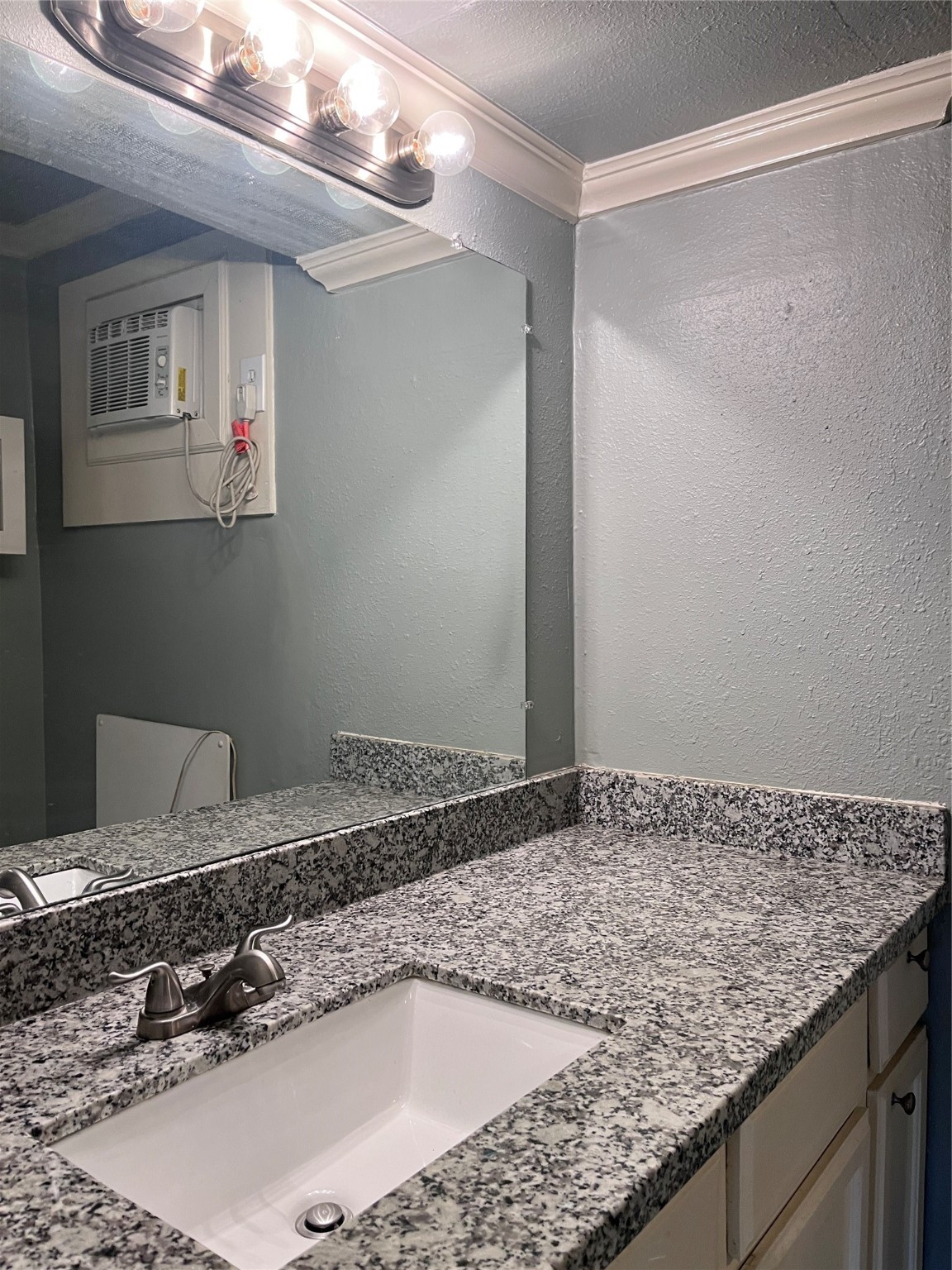 911 Byrne Street, Unit 2 Houston, TX 77009 - Photo 6 of 9 a bathroom with a granite countertop sink and a mirror