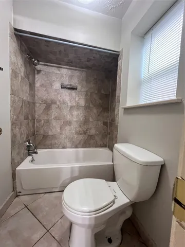 a bathroom with a toilet a sink and bathtub