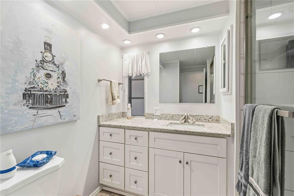 10303 Burnt Store Road, Unit 54 Punta Gorda, FL 33950 - Photo 14 of 27 a bathroom with a double vanity sink and a mirror