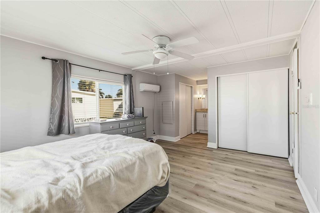 10303 Burnt Store Road, Unit 54 Punta Gorda, FL 33950 - Photo 15 of 27 a spacious bedroom with a bed and closet with wooden floor