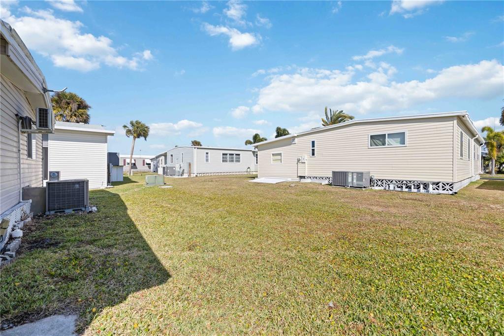 10303 Burnt Store Road, Unit 54 Punta Gorda, FL 33950 - Photo 19 of 27 a view of a house with a yard
