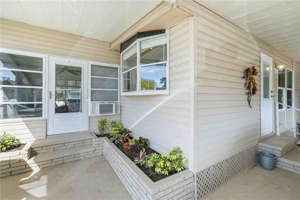 10303 Burnt Store Road, Unit 54 Punta Gorda, FL 33950 - Photo 2 of 27 a front view of a house with a garden