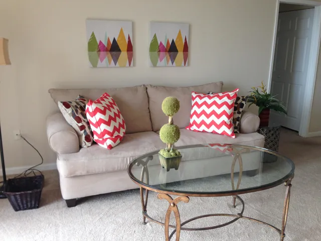 a living room with furniture and wall paintings