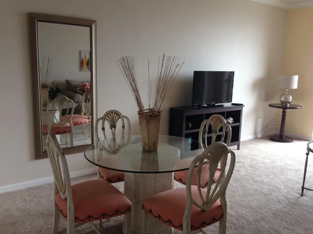 a dining room with furniture and wooden floor