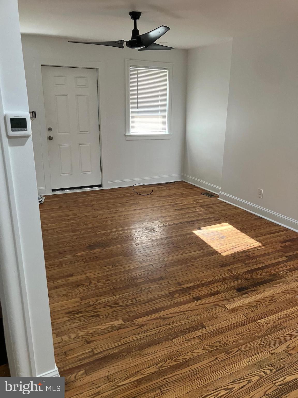3014 Memphis Street Philadelphia, PA 19134 - Photo 4 of 15 an empty room with wooden floor and windows