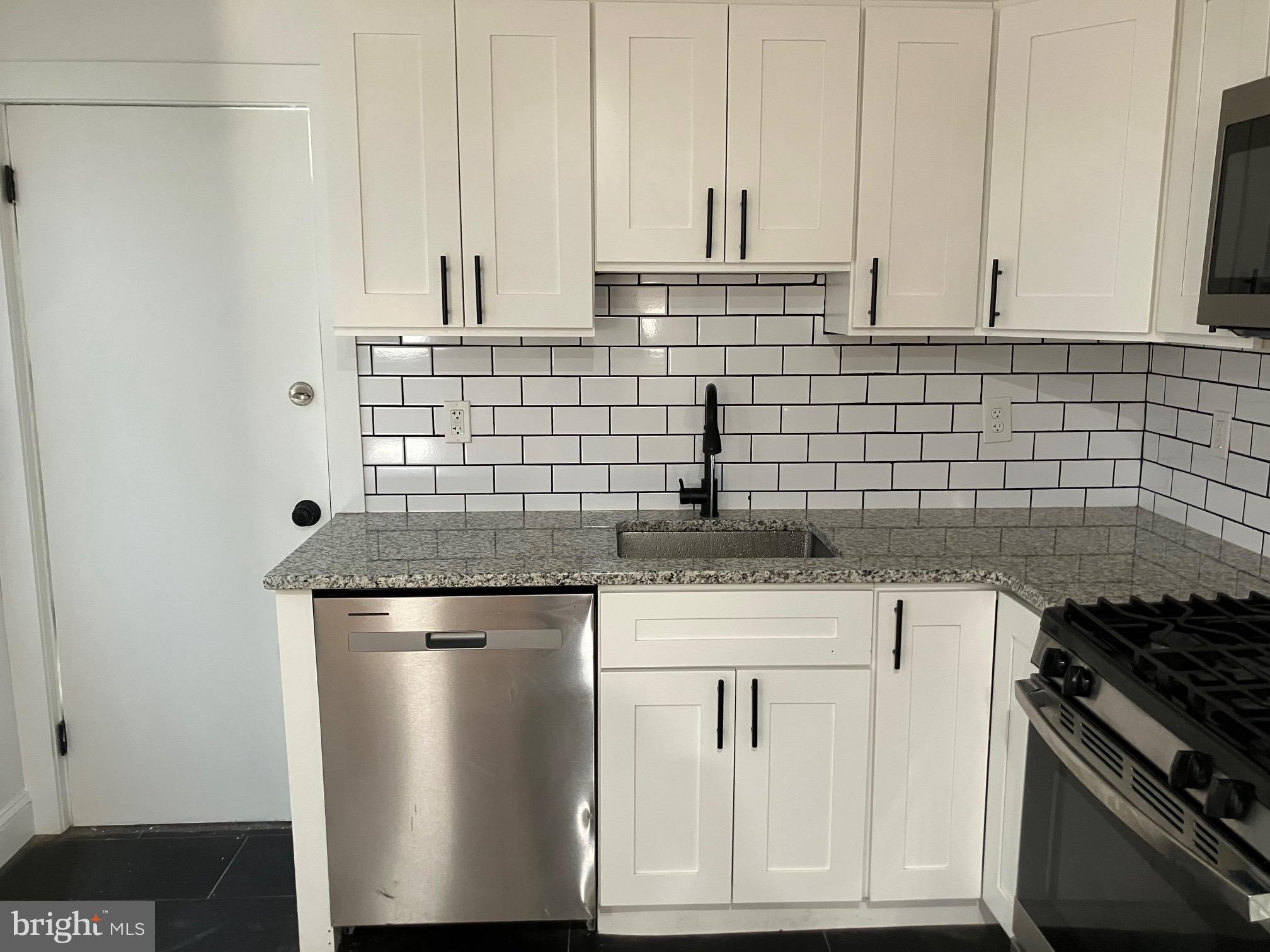 3014 Memphis Street Philadelphia, PA 19134 - Photo 7 of 15 a kitchen with stainless steel appliances granite countertop a sink stove and cabinets