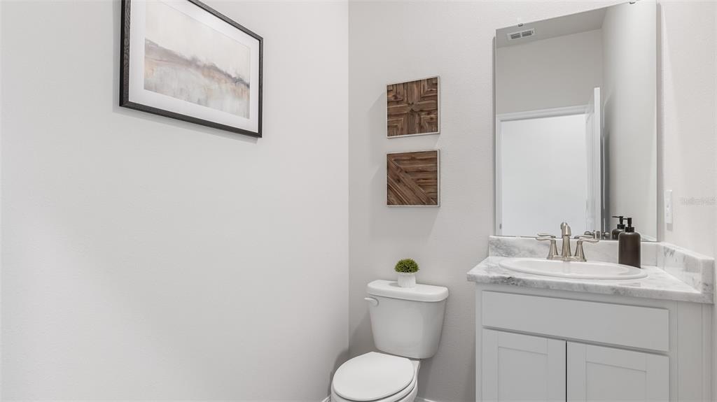 1709 Cobb Trail Parrish, FL 34219 - Photo 14 of 26 a bathroom with a toilet sink and mirror