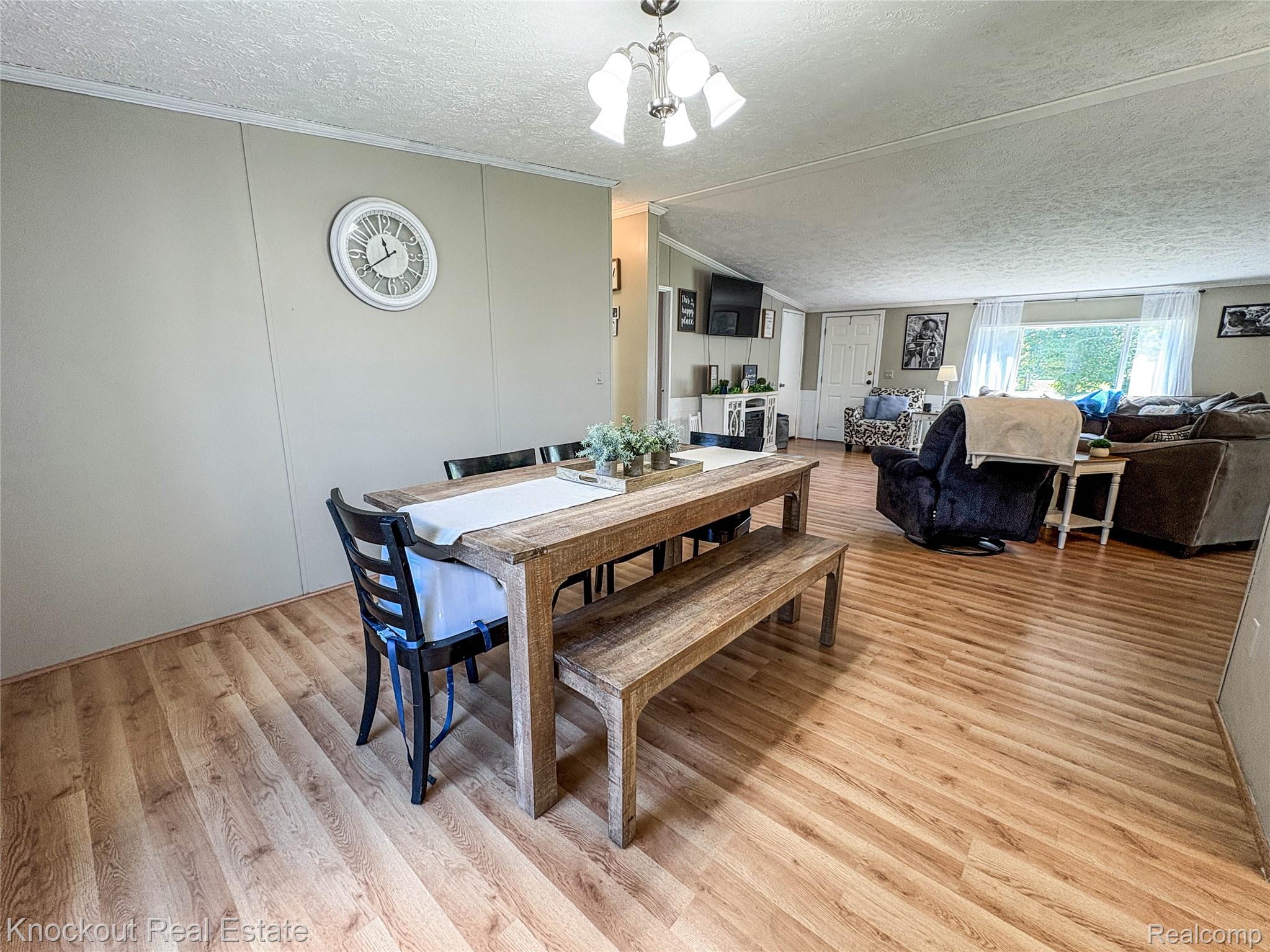 7760 Bell Road Birch Run, MI 48415 - Photo 12 of 68 Open-concept interior featuring wood-finish flooring, a neutral wall color, and a ceiling-mounted light fixture