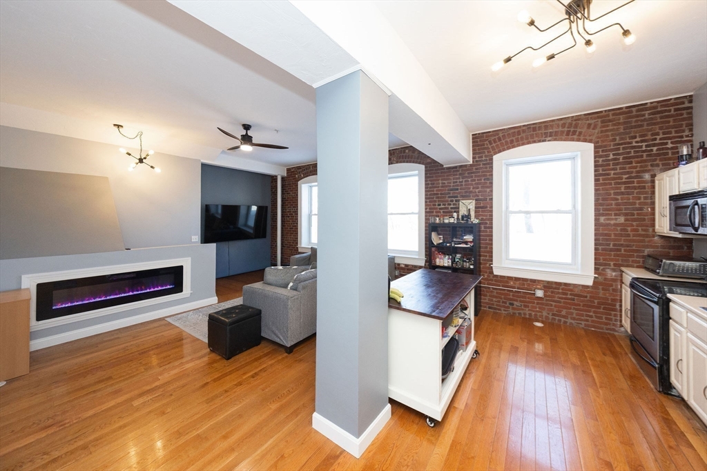32 Providence Street, Unit 5 Worcester, MA 01604 - Photo 13 of 42 a view of living room filled with furniture and wooden floor