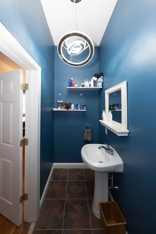32 Providence Street, Unit 5 Worcester, MA 01604 - Photo 14 of 42 a bathroom with a sink a mirror and a toilet