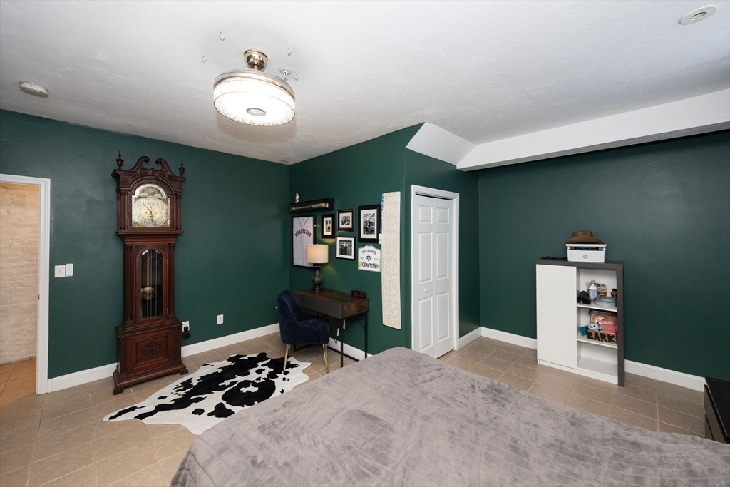 32 Providence Street, Unit 5 Worcester, MA 01604 - Photo 19 of 42 a bedroom with furniture and a chandelier