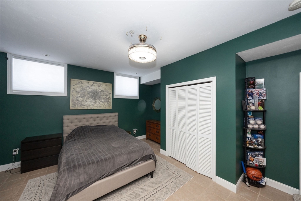 32 Providence Street, Unit 5 Worcester, MA 01604 - Photo 20 of 42 a bedroom with a bed and a chandelier