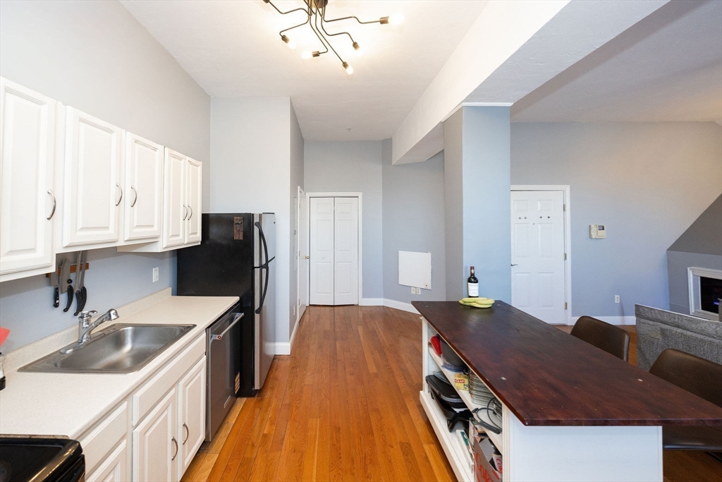 32 Providence Street, Unit 5 Worcester, MA 01604 - Photo 6 of 42 a kitchen with a sink refrigerator and cabinets