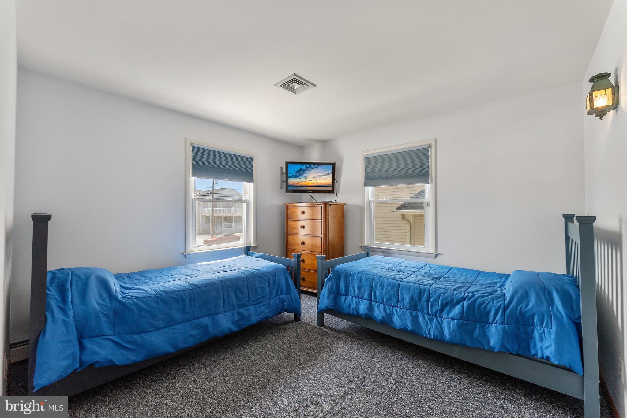 6500 Central Avenue, Unit SOUTH Sea Isle City, NJ 08243 - Photo 12 of 54 a bedroom with a bed and window