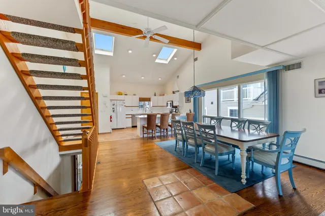 a dining room with furniture and wooden floor