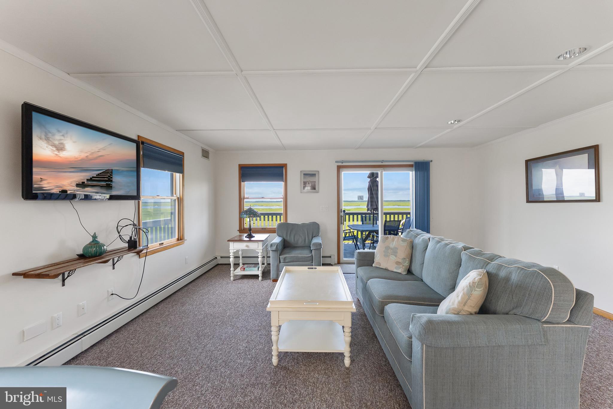 6500 Central Avenue, Unit SOUTH Sea Isle City, NJ 08243 - Photo 19 of 54 a living room with furniture and a flat screen tv