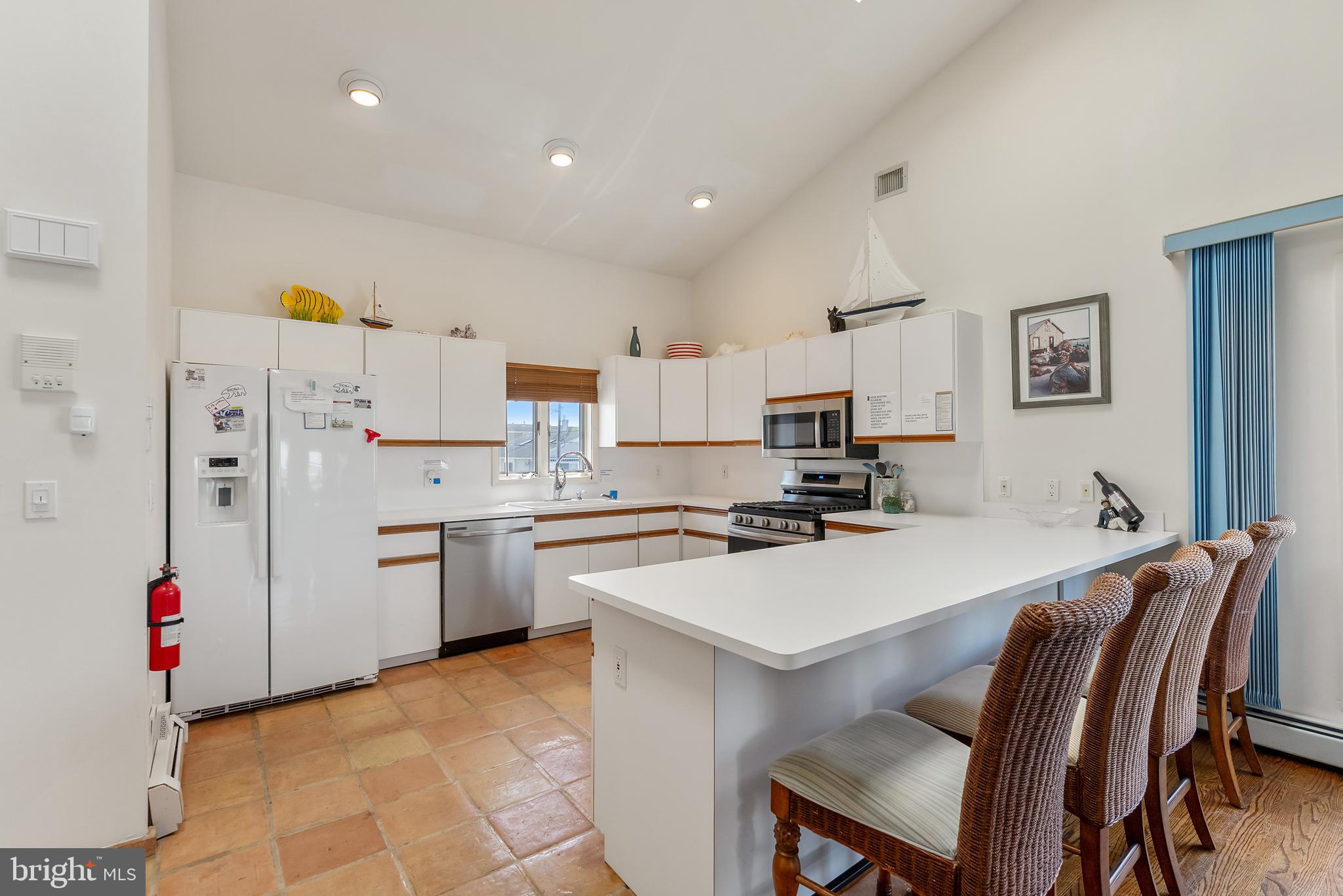 6500 Central Avenue, Unit SOUTH Sea Isle City, NJ 08243 - Photo 24 of 54 a kitchen that has a lot of cabinets a sink and a stove in it