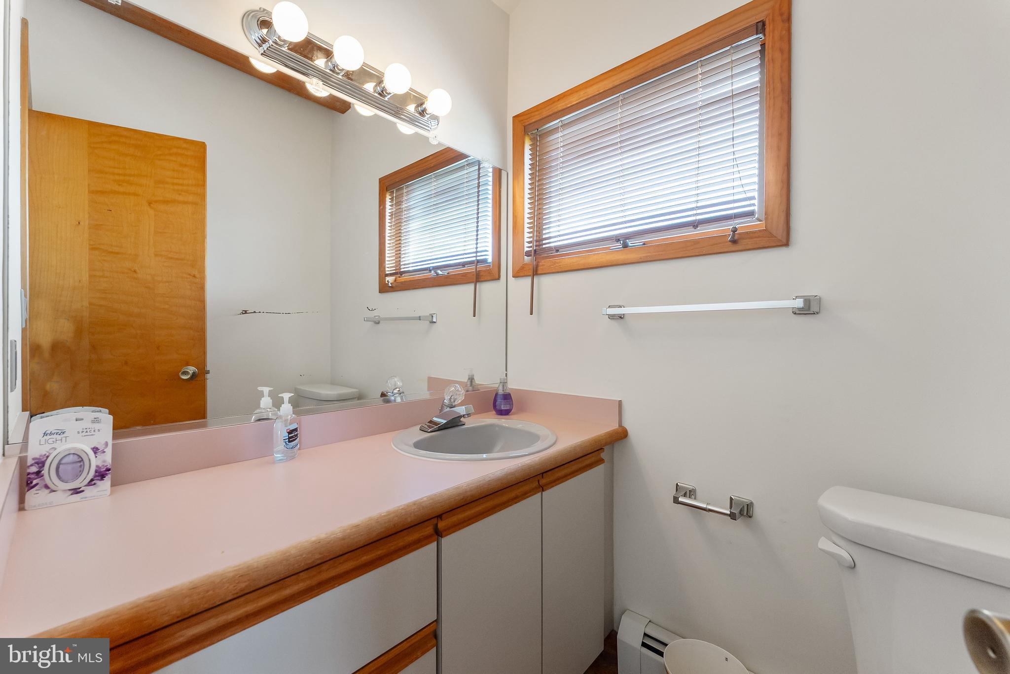 6500 Central Avenue, Unit SOUTH Sea Isle City, NJ 08243 - Photo 30 of 54 a bathroom with a sink a toilet and mirror