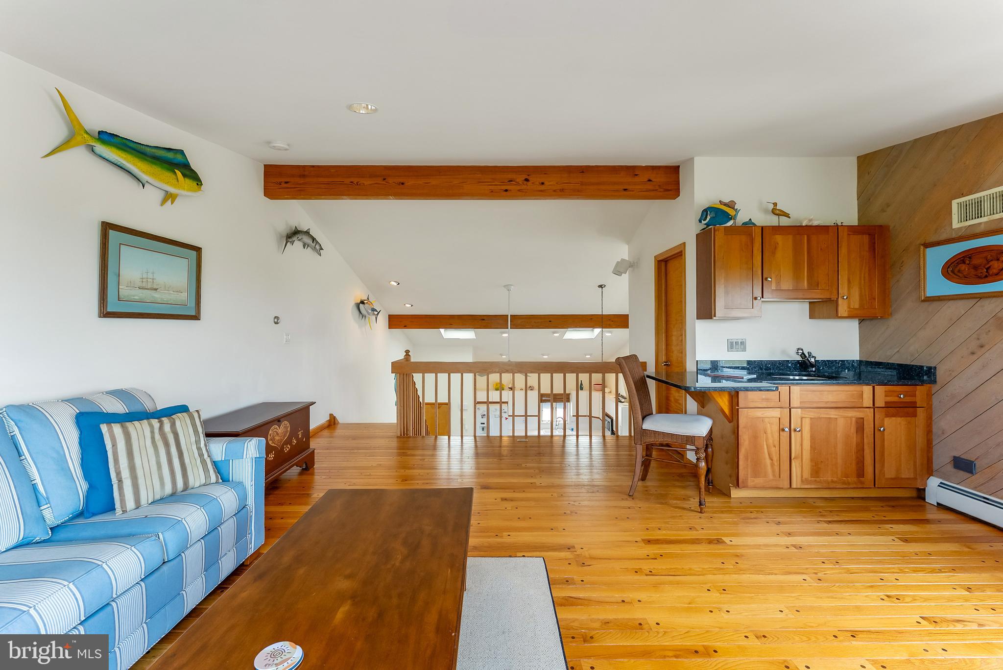 6500 Central Avenue, Unit SOUTH Sea Isle City, NJ 08243 - Photo 37 of 54 a living room with couches and kitchen view with wooden floor