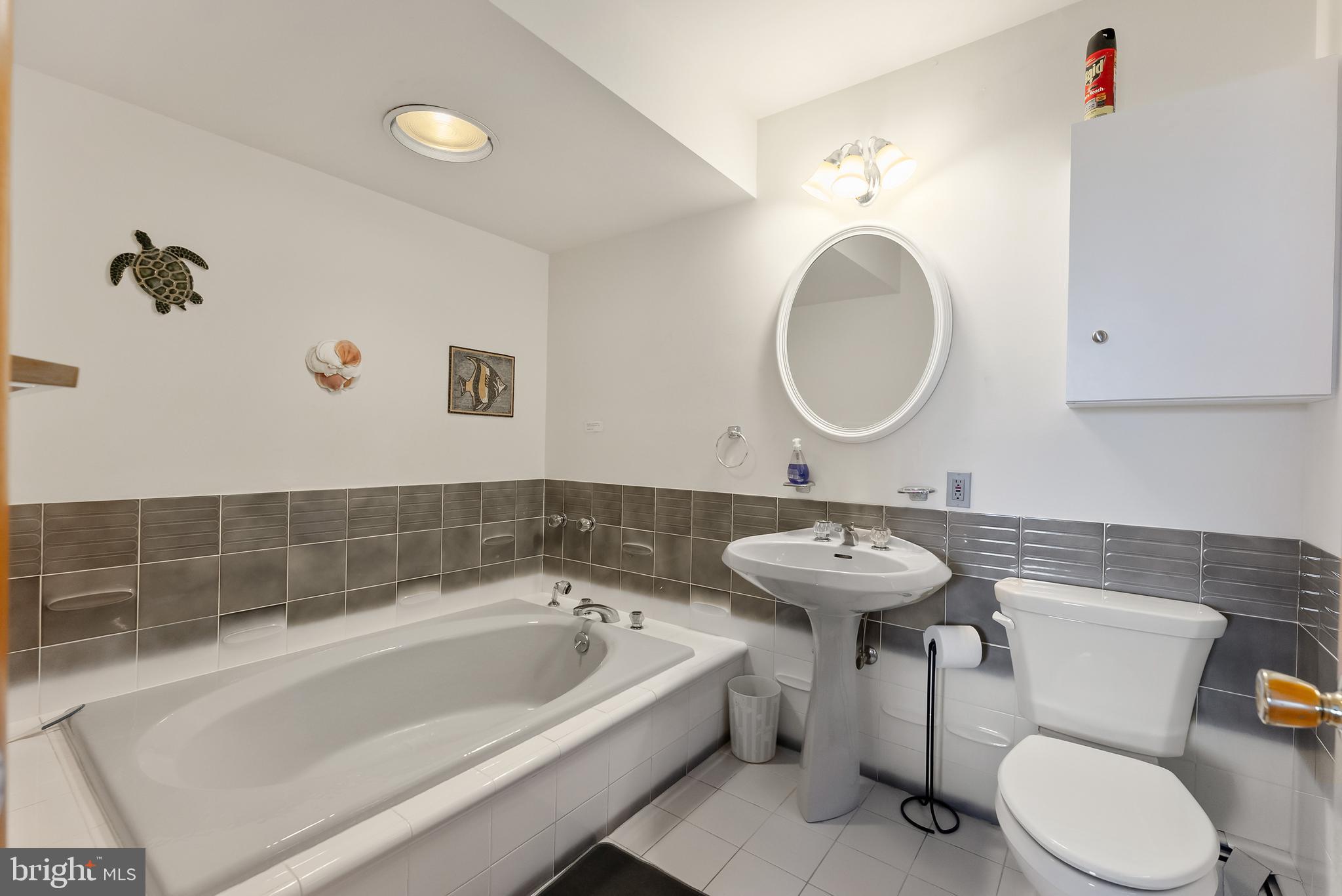 6500 Central Avenue, Unit SOUTH Sea Isle City, NJ 08243 - Photo 6 of 54 a bathroom with a sink and a mirror