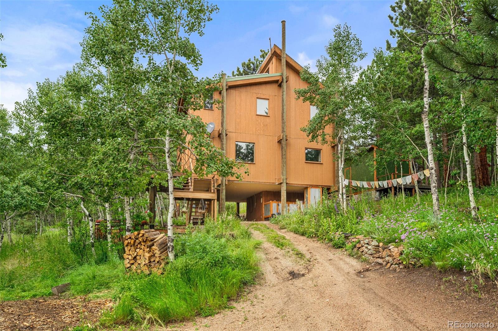 a view of a brick house with a big yard and large trees