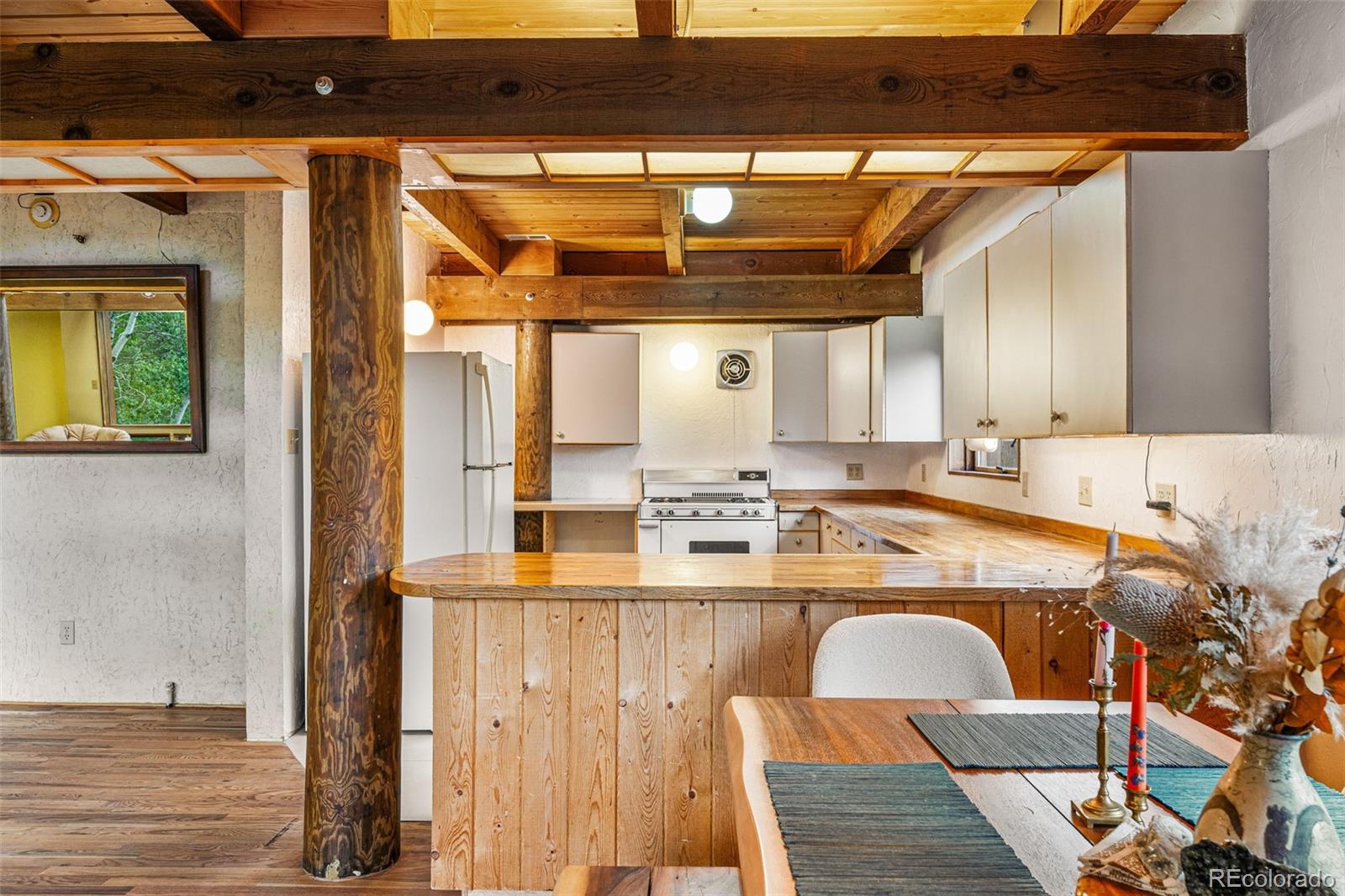 198 Range Road Nederland, CO 80466 - Photo 11 of 40 a view of a kitchen with a sink and dishwasher with wooden floor
