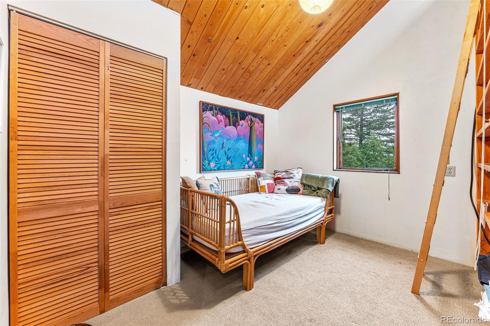 198 Range Road Nederland, CO 80466 - Photo 29 of 40 a bed sitting in a bedroom next to a window