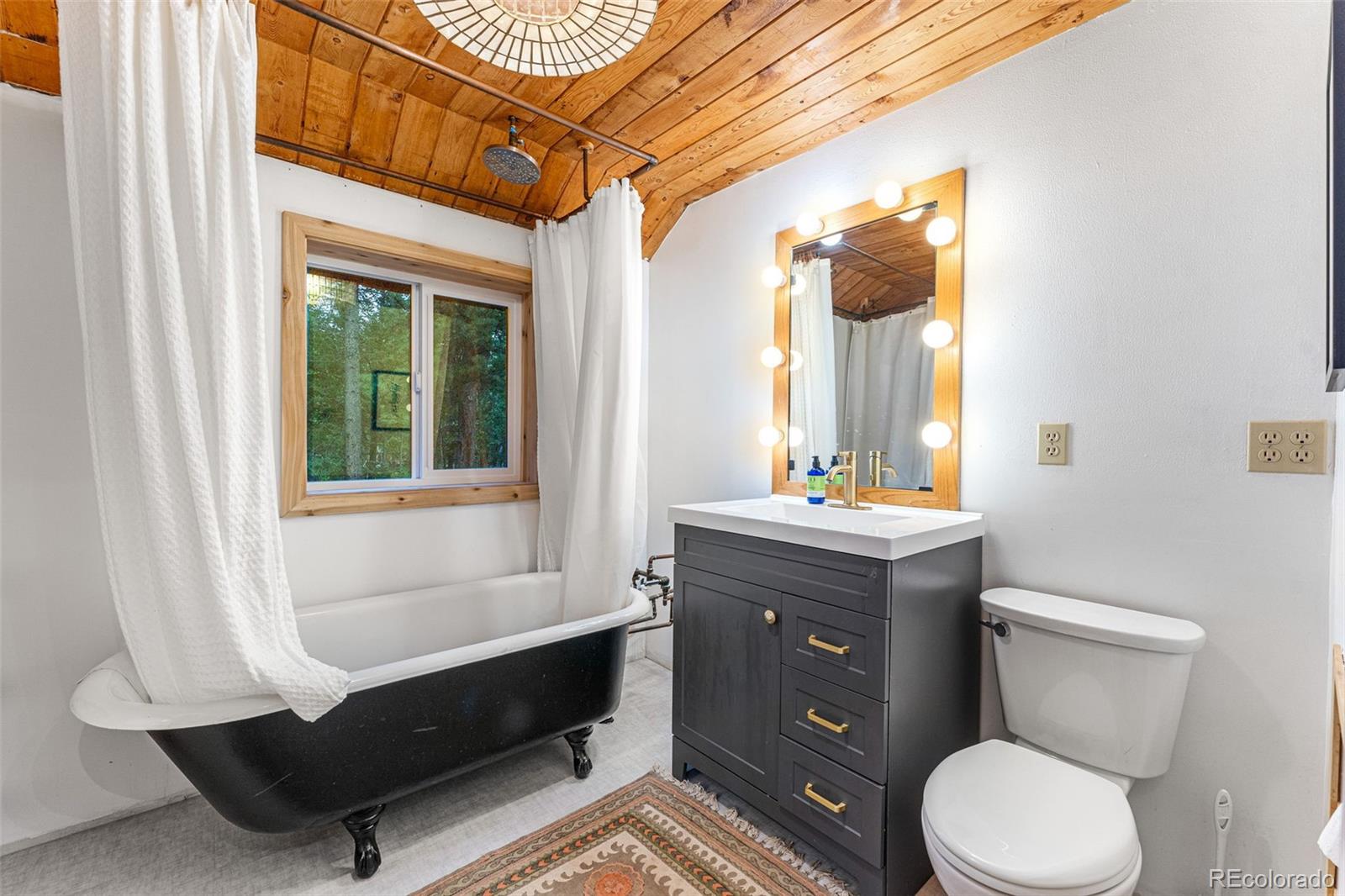 198 Range Road Nederland, CO 80466 - Photo 31 of 40 a bathroom with a toilet a sink and a window